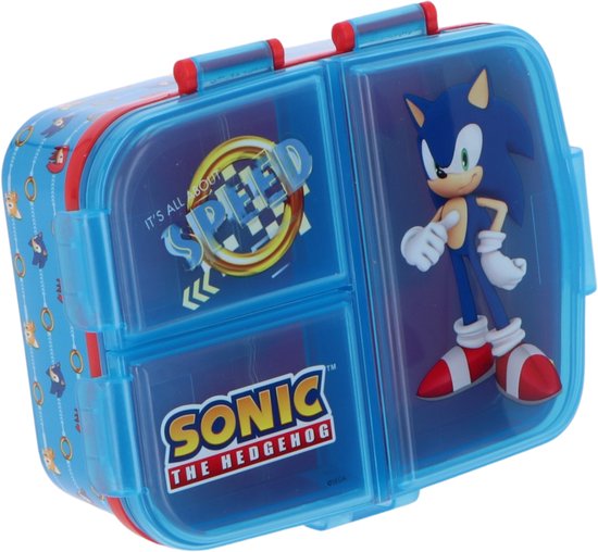 Blauwe lunchtrommel met Sonic the Hedgehog opdruk, 3 vakken, en rode sluitingen. Tekst 'SONIC THE HEDGEHOG' en 'IT'S ALL ABOUT SPEED'.