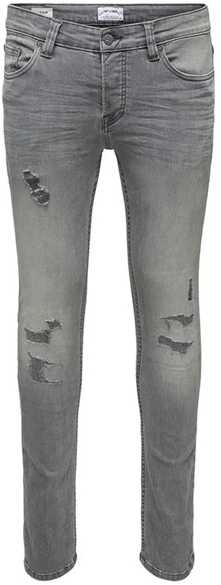 Grijze skinny jeans met scheuren op de dijen en knieën.