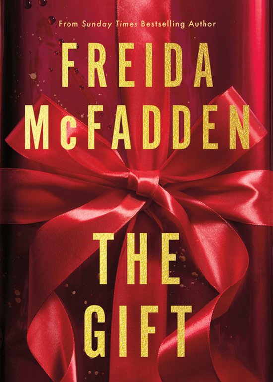 Boekomslag van 'The Gift' van Freida McFadden, met een grote rode strik op een glanzende rode achtergrond.
