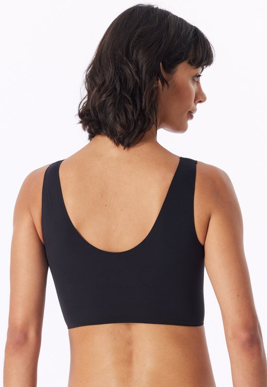 Zicht op de achterkant van een zwarte bustier met V-hals, gedragen door een model.