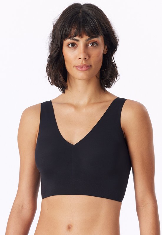 Zwarte bustier met V-hals, gedragen door een model met donkerbruin krullend haar.