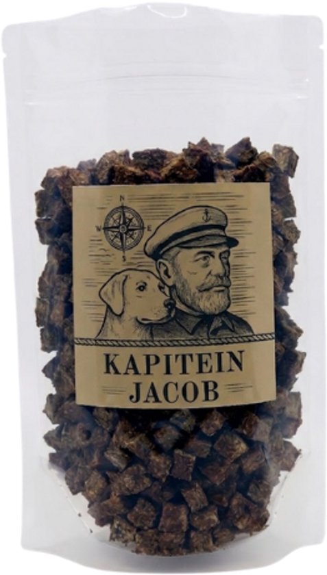 Doypack met Kapitein Jacob hondensnoepjes. Op het etiket staat een kapitein met een hond en een kompas. Tekst: KAPITEIN JACOB.