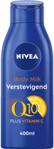 Blauwe NIVEA Body Milk fles met gele 'Q10 PLUS VITAMIN C' en sinaasappelsplinter. 400ml.
