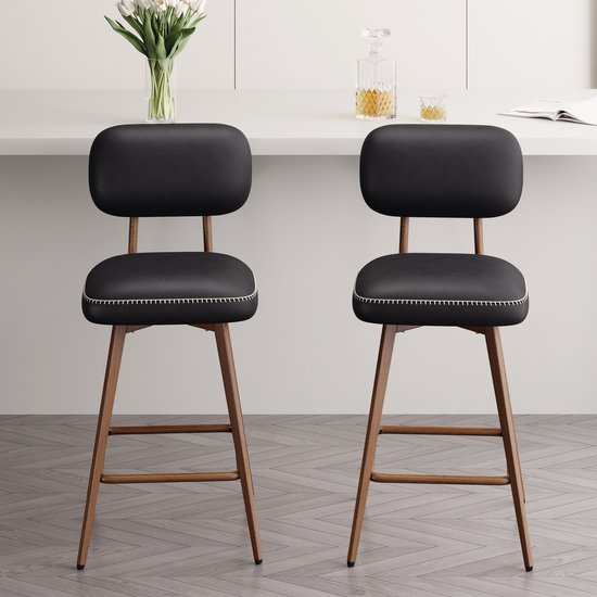 Twee zwarte barkrukken met metalen frame en zitting met witte stiksels.