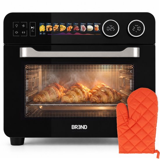 Zwarte airfryer oven met open deur, waarin goudbruine croissants op een rooster liggen te garen. Een oranje ovenwant ligt rechts ernaast.