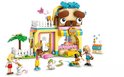 Animalerie LEGO Friends avec une grosse tête de chien comme toit, briques violettes, jaunes, bleues et roses. Comprend trois mini-poupées, un chiot, un chaton et un lapin.