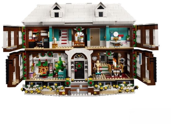 Open LEGO-huis met gedetailleerde kamers, waaronder een kerstboom en eettafel.
