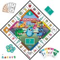 Monopoly Junior speelbord met dinosaurussen, kat, pinguïn, hond, geld en kaarten.