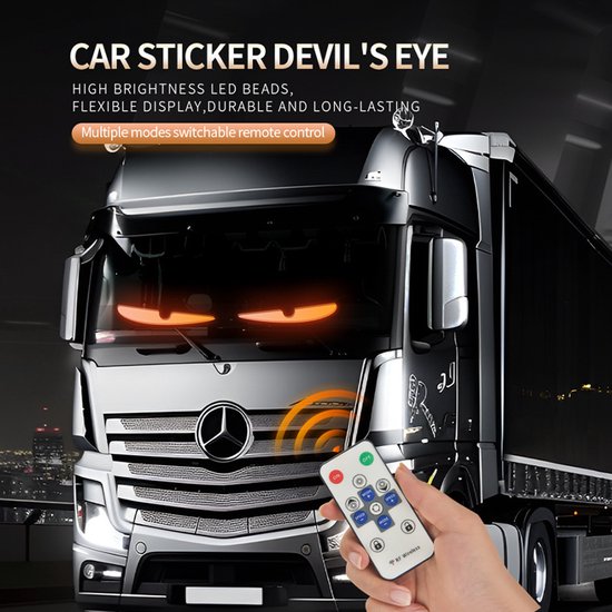 Een vrachtwagen met oranje 'devil eyes' LED-stickers op de voorruit. Een hand houdt een afstandsbediening met knoppen vast.