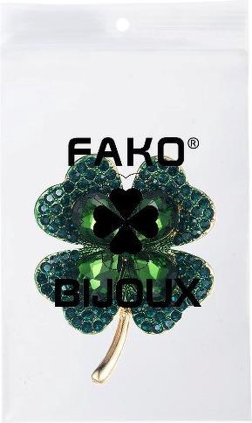 Gouden klaverbroche met groene stenen in verpakking met "FAKO BIJOUX".