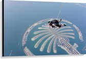 Canvas - Parachutespringer boven de Palm van Dubai - 120x80 cm Foto op Canvas Schilderij (Wanddecoratie op Canvas)