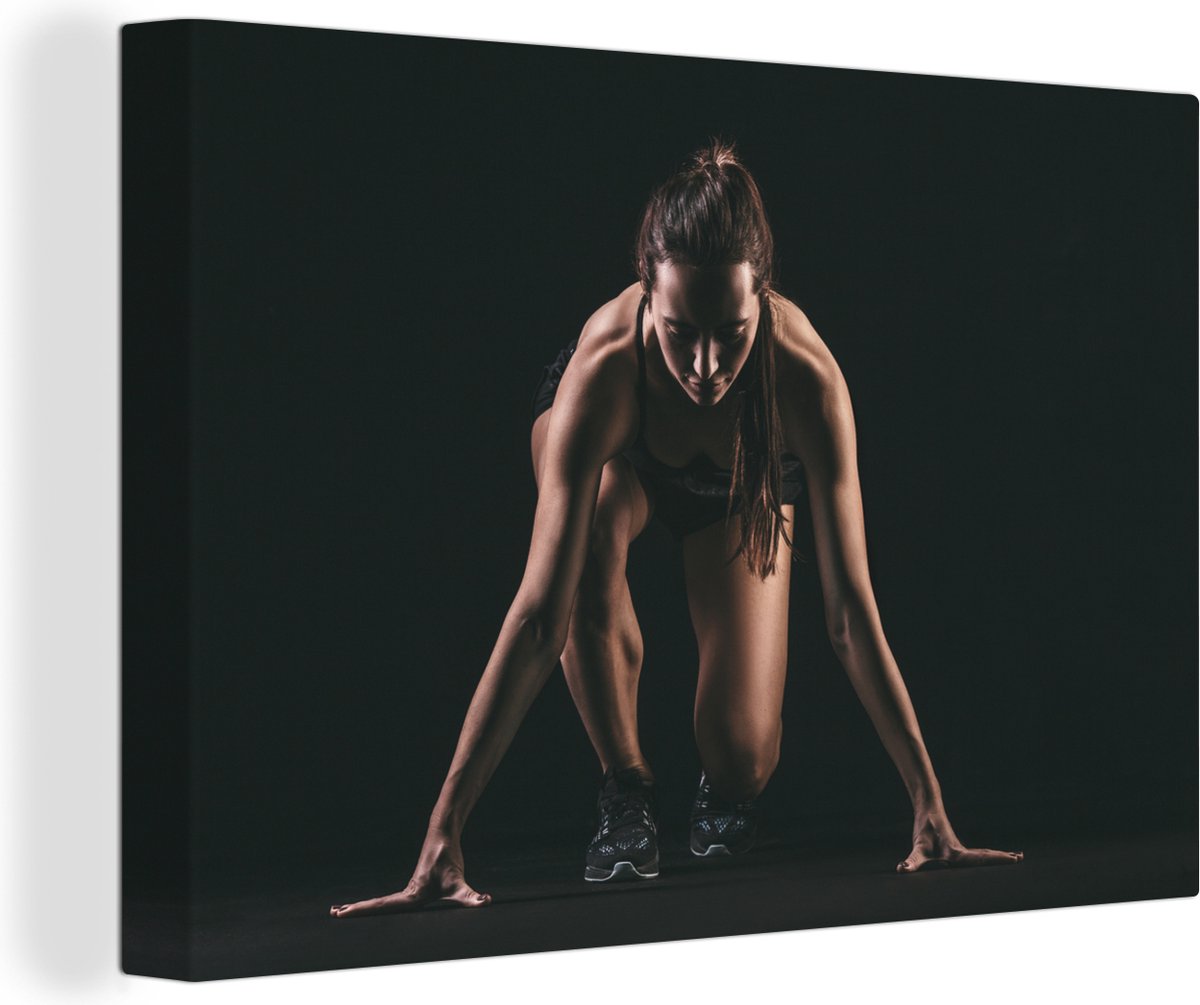 Canvas Schilderij Vrouwelijk sporter op zwarte achtergrond - 30x20 cm - Wanddecoratie - OneMillionCanvasses