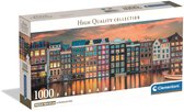 Doos van een 1000-stukjes legpuzzel met een panorama van Amsterdam bij zonsondergang.