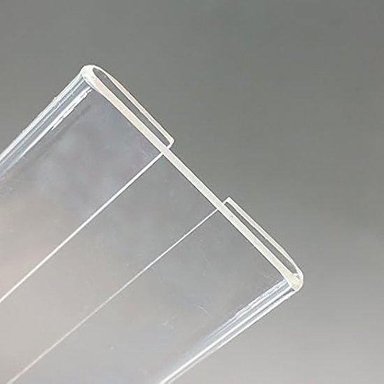 Close-up van de gebogen rand van een transparante acryl houder.