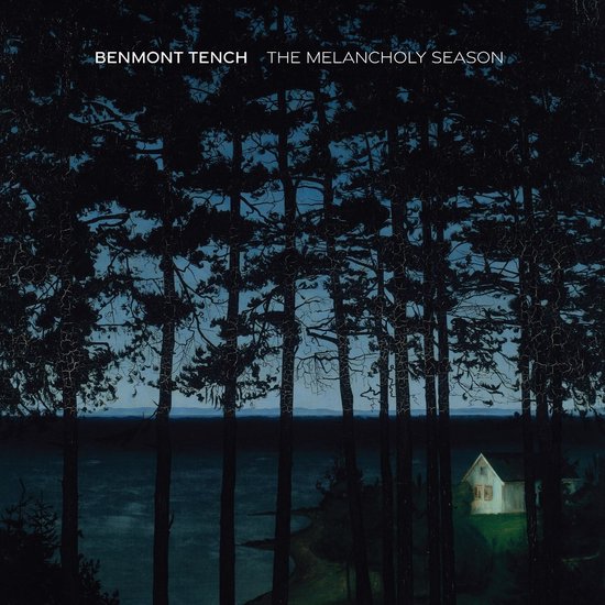 Albumhoes 'Benmont Tench - The Melancholy Season' met donkere bomen en een huisje aan een meer.