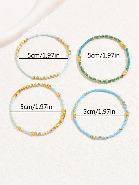 Vier armbandjes met lichtblauwe, turquoise en gouden kraaltjes, met maatindicatie 5cm/1.97in.