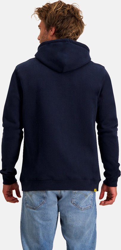 Man met blauwe jeans en donkerblauwe hoodie, rug zichtbaar.