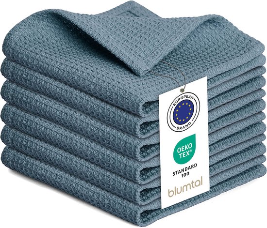 Een stapel van zes lichtblauwe wafeldoeken met een label.