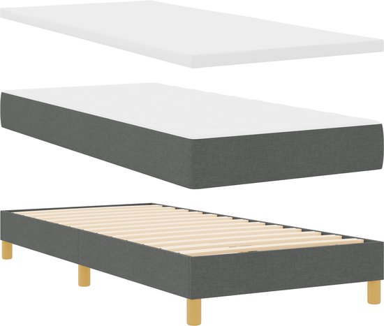 Gestoffeerd bedframe in donkergrijs met houten lattenbodem, matras en topmatras.