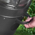 Hand die een zwarte, ergonomische handgreep vastpakt aan de zijkant van een gespikkelde zilverkleurige terrasverwarmer.