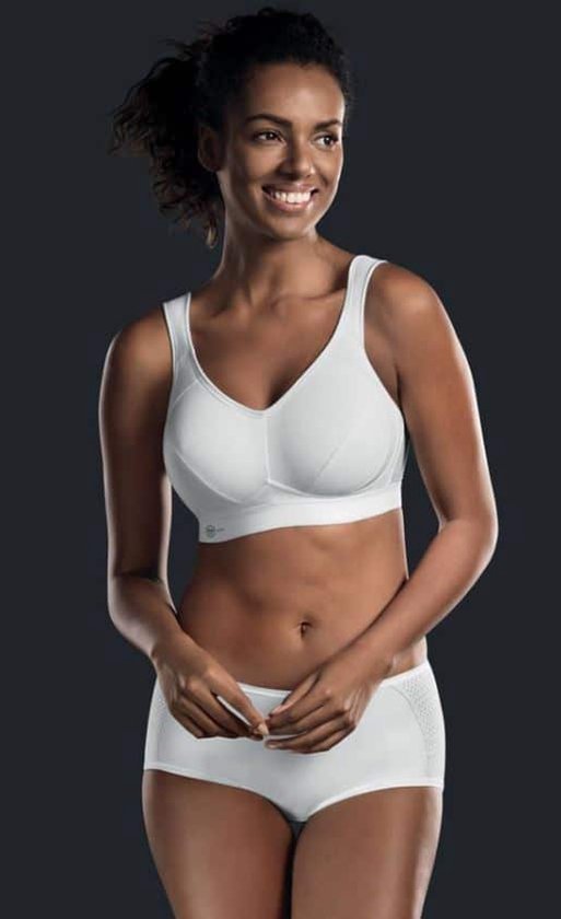 Model met witte sportbeha en witte shorts met zijkanten van mesh.