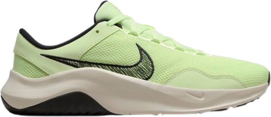 Chaussure d'entraînement Nike vert citron avec Swoosh noir détaillé et semelle crème.