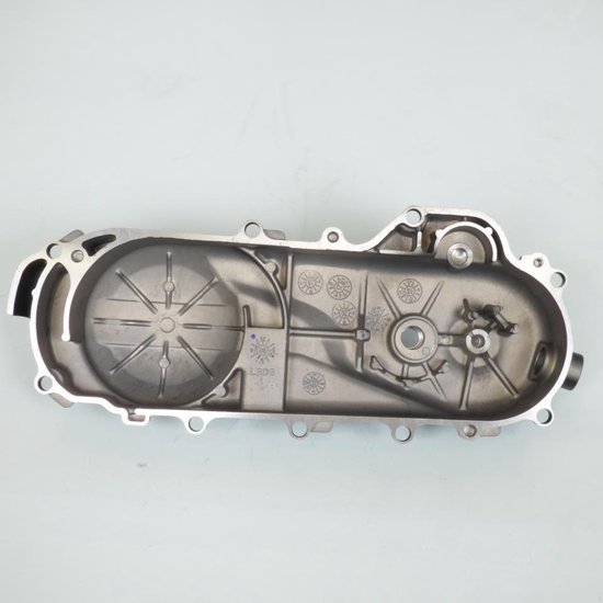 Boîtier de transmission en aluminium avec motifs de pignons internes et marquages.