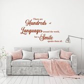 Muursticker There Are Hundreds Of Languages Around The World But A Smile -  Bruin -  80 x 46 cm  -  alle muurstickers  woonkamer  engelse teksten - Muursticker4Sale