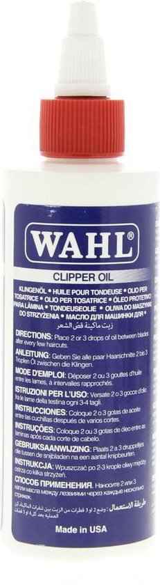 Wahl Clipper Oil flesje met rode dop en blauw label met meertalige instructies.