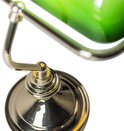 Détail du bras doré et du point de pivot d'une lampe de bureau verte.