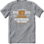 87 Jaar Legend T-Shirt | Goud - Wit | Grappig Verjaardag en Feest Cadeau Shirt | Dames - Heren - Unisex | Tshirt Kleding Kado | - Donker Grijs - Gemaleerd - M