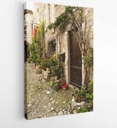 Canvas schilderij - Foliage along the walls of a home in a small Saint-Paul-de-Vence village -  106599665 - 40-30 Vertical