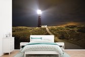 Behang - Fotobehang Een verlichte vuurtoren op het eiland Schiermonnikoog - Breedte 450 cm x hoogte 300 cm