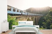 Behang - Fotobehang Een trein over een brug - Breedte 420 cm x hoogte 280 cm