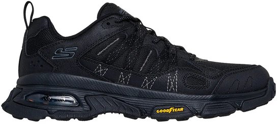Zijkant van een zwarte Skechers wandelschoen met Goodyear zool en zichtbare luchtdemping.