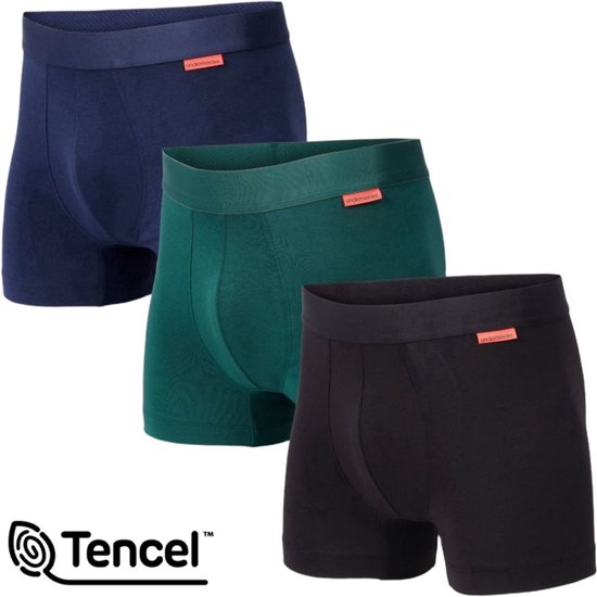 Drie boxeshorts in donkerblauw, donkergroen en zwart, met oranje labels. Tencel logo.