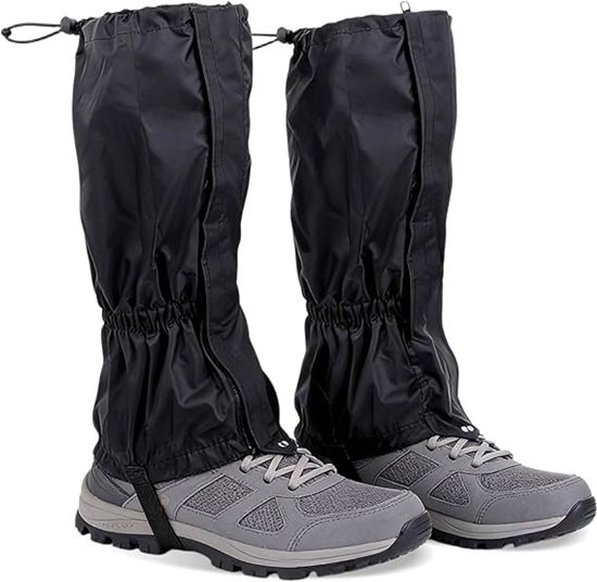 Zwarte, hoge gamaschen met rits en aantrekkoord, over grijze wandelschoenen.
