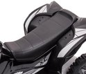Close-up van het zwarte, gevoerde zadel en de zijkant van de Vrooomy kinderquad met 'XC Sport' logo.