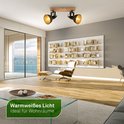 Inbouwspot met houten balk, twee donkere spots en warm wit licht in een woonkamer.
