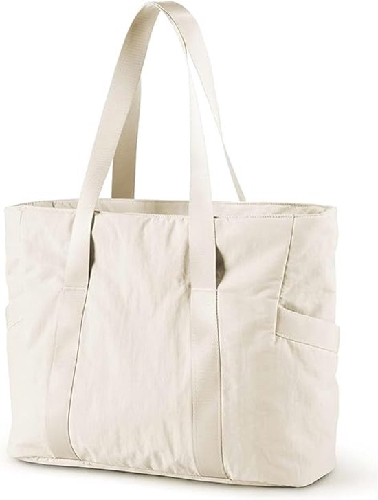 Un sac fourre-tout blanc cassé avec des bretelles en tissu et des poches extérieures sur fond blanc.