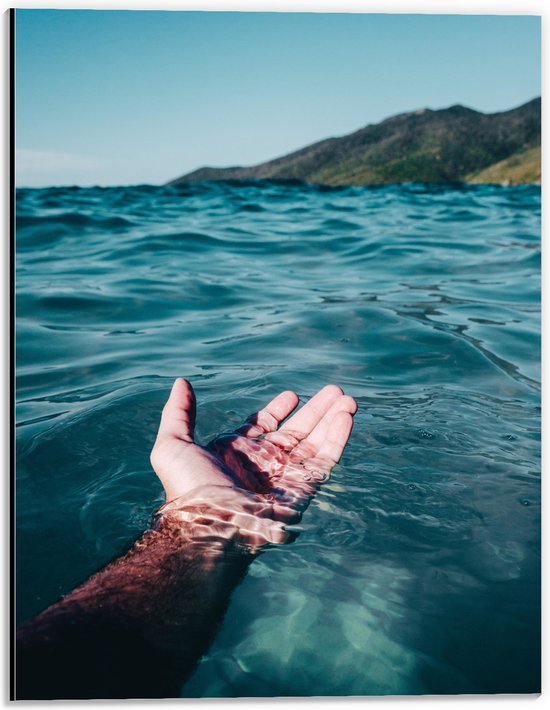 WallClassics - Dibond - Hand in Helderblauw Water met Bergen - 30x40 cm Foto op Aluminium (Met Ophangsysteem)