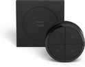 Zwarte Philips Hue tap-dial switch met vier knoppen en een vierkant basisstation.