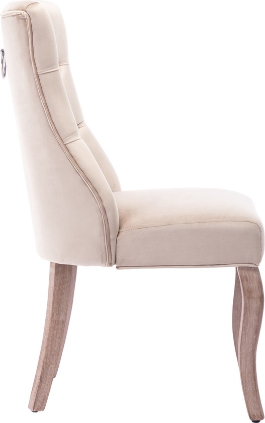 Zijaanzicht beige fluwelen eetkamerstoel met knopquilting op de rug. Houten poten.