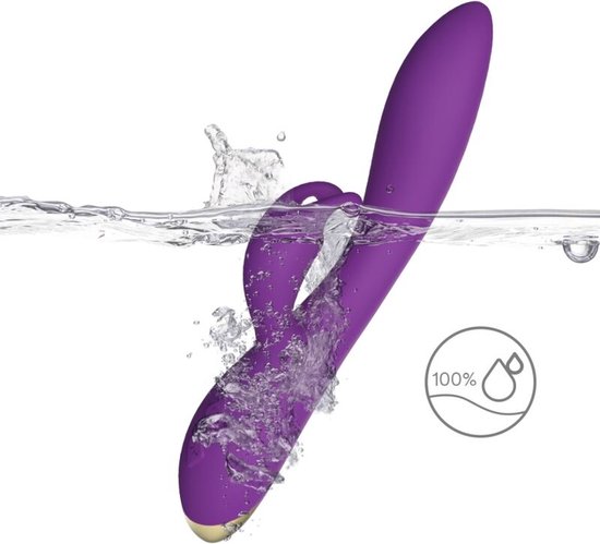 Vibrateur violet avec oreilles de lapin dans l'eau, 100% étanche.