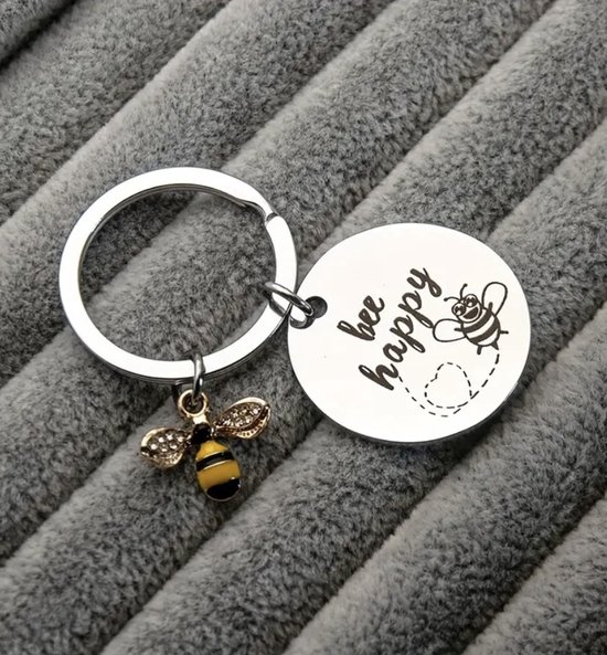 Bee Happy Sleutelhanger - Zilveren finish - Diameter 3 cm - Duurzaam Metaal - Elegante Bijenbedel met Details en Steentjes - Gegraveerde Inspirerende Boodschap ‘Bee Happy’ - Perfect als Cadeau - Makkelijke Bevestiging aan Sleutels of Tas