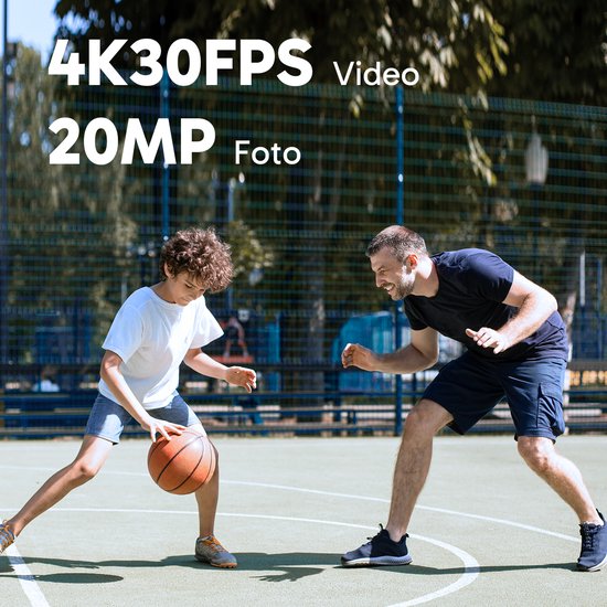 Een vader en zoon spelen basketbal op een buitenterrein. De vader kijkt lachend naar de zoon.