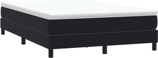 Zwart gestoffeerd boxspringbed met matras, op vier poten.