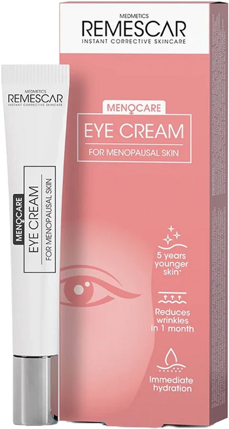 Witte tube oogcrème met grijze dop naast een roze doosje met de tekst "Menocare Eye Cream".