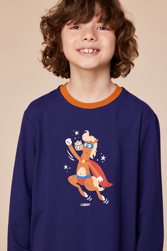 Garçon portant un haut de pyjama bleu foncé à poignets orange avec un imprimé de poney en super-héros.