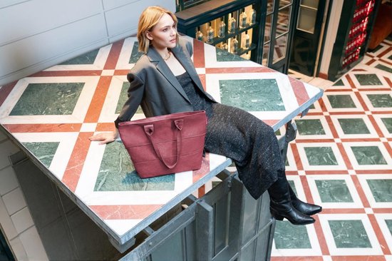 Dames zittend op tafel met bordeauxrode shopper met horizontale ribbels.